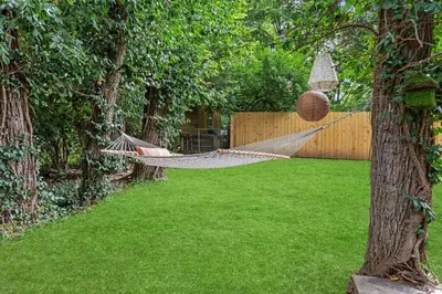 a hammock in a backyard with a yard at The Luxe/HotTub/Playground/12min KHP/30min Ark in Georgetown