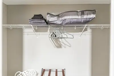 a shelf with towels and clothes on it in a room at Downtown/Bengals/Reds/TQL/OTR in Cincinnati