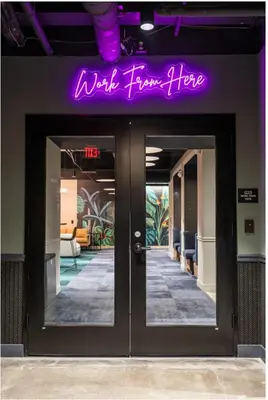 a purple sign above the doors of a building at Downtown/Bengals/Reds/TQL/OTR in Cincinnati