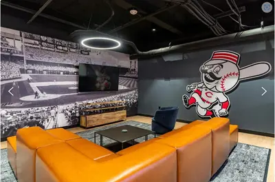 a room with a couch and a wall with a baseball mural at Downtown/Bengals/Reds/TQL/OTR in Cincinnati