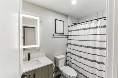 a bathroom with a toilet and a sink and a shower at Downtown/Bengals/Reds/TQL/OTR in Cincinnati