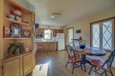 a kitchen with a table and chairs and a refrigerator at Quaint Youngstown Home about 2 Mi to Boardman Park! in Youngstown