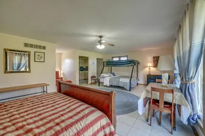 a bedroom with a bed and a bed and a table at Quaint Youngstown Home about 2 Mi to Boardman Park! in Youngstown