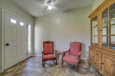 two chairs and a table in a room with a door at Quaint Youngstown Home about 2 Mi to Boardman Park! in Youngstown