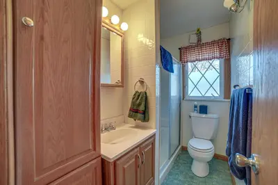 a bathroom with a toilet and a sink at Quaint Youngstown Home about 2 Mi to Boardman Park! in Youngstown