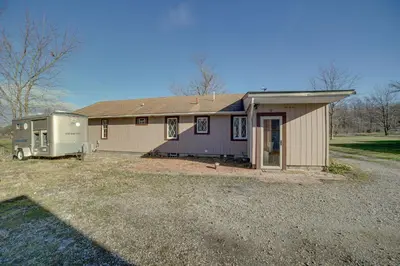 a house with a trailer in front of it at Quaint Youngstown Home about 2 Mi to Boardman Park! in Youngstown