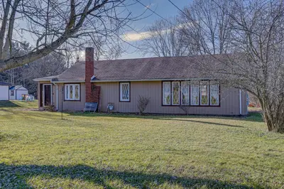 a small house with a lawn in front of it at Quaint Youngstown Home about 2 Mi to Boardman Park! in Youngstown