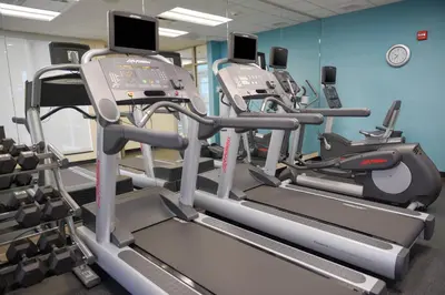 a gym with several tread machines in a room at Fairfield Inn and Suites Canton South in Canton