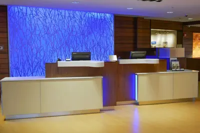 an empty lobby with a blue screen in a building at Fairfield Inn and Suites Canton South in Canton