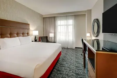 a hotel room with a large bed and a television at Drury Plaza Hotel Cincinnati Florence in Florence
