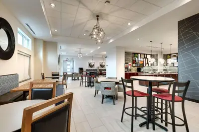 a restaurant with tables and chairs in a room at Drury Plaza Hotel Cincinnati Florence in Florence
