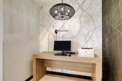 a desk with a computer on top of it at Drury Plaza Hotel Cincinnati Florence in Florence