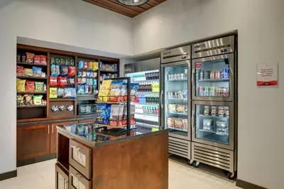 a store with a refrigerator and a counter with food at Drury Plaza Hotel Cincinnati Florence in Florence