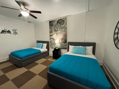 a bedroom with two beds and a ceiling fan at Beautiful Bungalow on Main in Madison