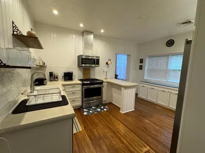 a kitchen with a stove and a sink at Beautiful Bungalow on Main in Madison