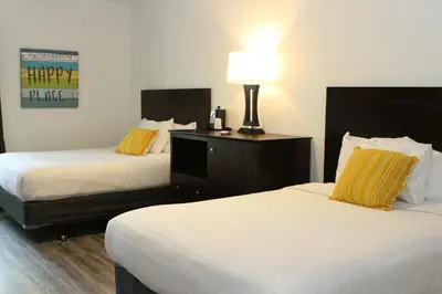 a hotel room with two beds and a lamp at Bay Lodging Resort in Put-in-Bay