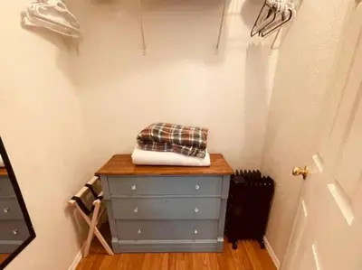 a dressing room with a blue dresser and a door at Rise and Shine! A Gorge-ous cabin! in Korea