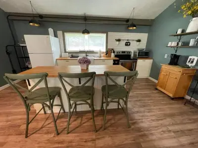a kitchen with a table and four chairs in it at Rise and Shine! A Gorge-ous cabin! in Korea