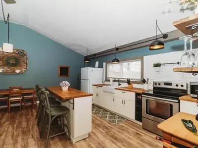 a kitchen with blue walls and a table and chairs at Rise and Shine! A Gorge-ous cabin! in Korea