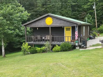 a house with a sun sign on the front of it at Rise and Shine! A Gorge-ous cabin! in Korea