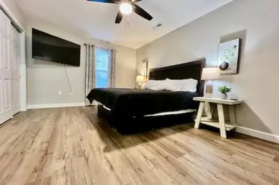 a bedroom with a black bed and a ceiling fan at Nicest New construction Home in Middletown, Ohio in Middletown