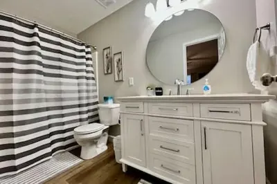 a bathroom with a sink and a toilet and a mirror at Nicest New construction Home in Middletown, Ohio in Middletown