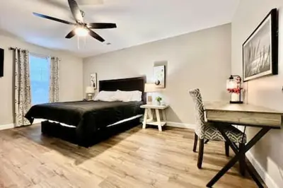 a bedroom with a bed and a desk and a ceiling fan at Nicest New construction Home in Middletown, Ohio in Middletown