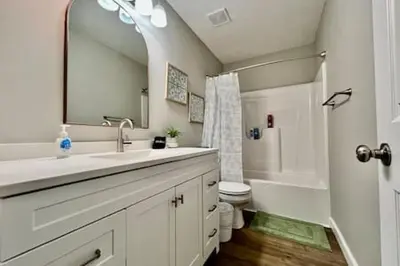 a bathroom with a sink and a toilet and a mirror at Nicest New construction Home in Middletown, Ohio in Middletown