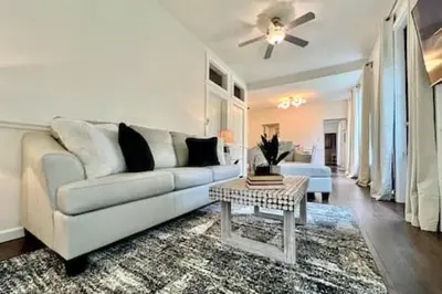 a living room with a white couch and a table at 1 Bd Hide away Historic Dayton, Oh Oregon District in Dayton