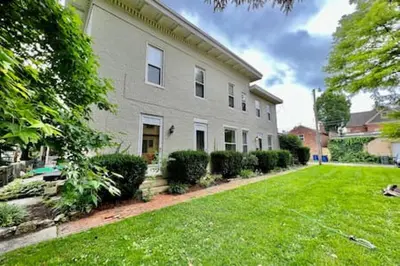 a large white house with a grass yard at 1 Bd Hide away Historic Dayton, Oh Oregon District in Dayton