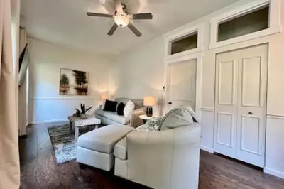 a living room with a white couch and a ceiling fan at 1 Bd Hide away Historic Dayton, Oh Oregon District in Dayton