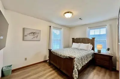 a bedroom with a bed and two windows at Charming remodeled 2 bed GEM Middletown in Middletown