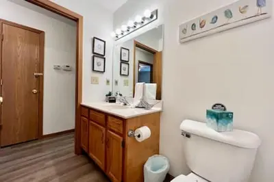 a bathroom with a toilet and a sink and a mirror at Charming remodeled 2 bed GEM Middletown in Middletown