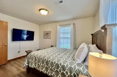 a bedroom with a bed and a flat screen tv at Charming remodeled 2 bed GEM Middletown in Middletown