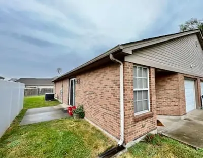 a brick house with a driveway in front of it at Charming remodeled 2 bed GEM Middletown in Middletown
