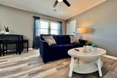 a living room with a blue couch and a table at Sleek remodeled Design 2 Bed Trenton, OH Apartment in Trenton