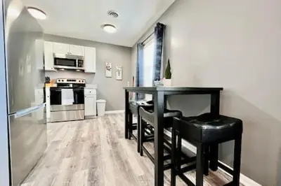 a kitchen with a black table and black chairs at Sleek remodeled Design 2 Bed Trenton, OH Apartment in Trenton