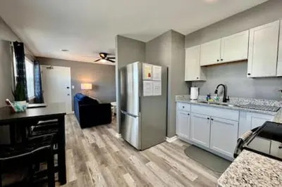 a kitchen with white cabinets and a stainless steel refrigerator at Sleek remodeled Design 2 Bed Trenton, OH Apartment in Trenton
