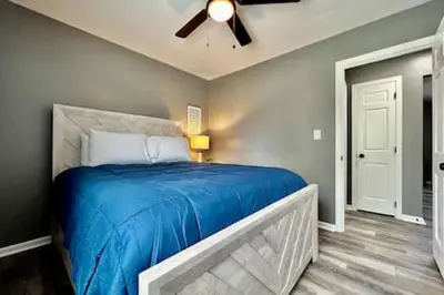 a bedroom with a blue bed with a ceiling fan at Sleek remodeled Design 2 Bed Trenton, OH Apartment in Trenton