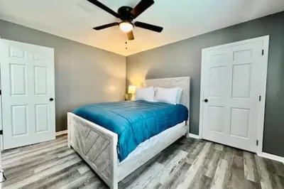 a bedroom with a bed with a ceiling fan at Charming, Stylish remodeled Trenton Apartment in Trenton
