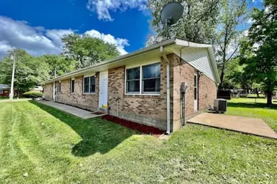 a brick house in a yard with a grass field at Remodeled 2 BDRM Ranch Attached Home Liberty, TWP in Rockdale
