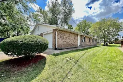 a brick house with a garage in a yard at Remodeled 2 BDRM Ranch Attached Home Liberty, TWP in Rockdale