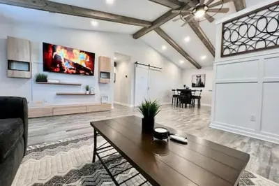 a living room with a table and a dining room at Amazing riverside New Construction home in Middletown in Middletown