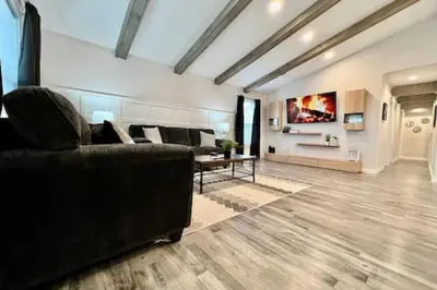 a living room with a couch and a table at Amazing riverside New Construction home in Middletown in Middletown