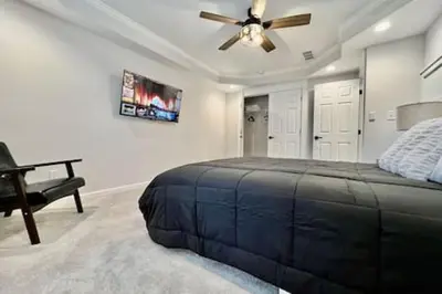 a bedroom with a bed and a ceiling fan at Amazing riverside New Construction home in Middletown in Middletown