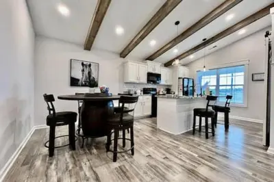 a kitchen with a table and chairs in a room at Amazing riverside New Construction home in Middletown in Middletown