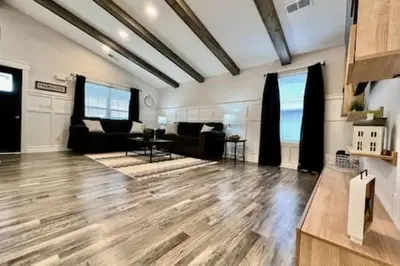 a large living room with a hard wood floor at Amazing riverside New Construction home in Middletown in Middletown