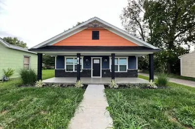 an orange and blue house with a sidewalk in front of it at Amazing riverside New Construction home in Middletown in Middletown
