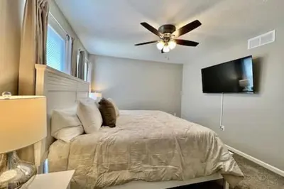 a bedroom with a bed with a ceiling fan at Brand New Home Walking distance to Spooky Nook in Hamilton