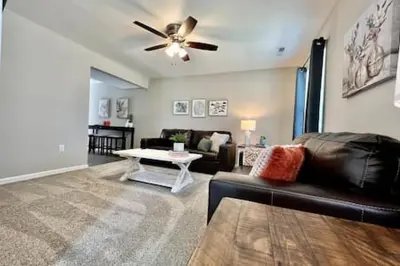 a living room with a couch and a ceiling fan at Brand New Home Walking distance to Spooky Nook in Hamilton